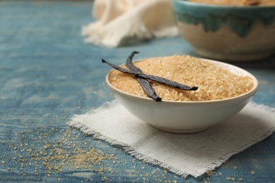 Photo of Bowl with brown vanilla sugar on wooden table