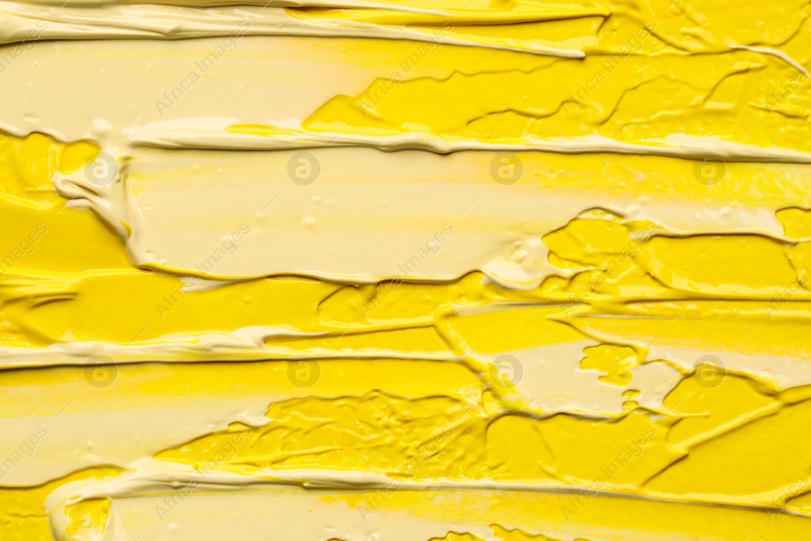 Photo of Beautiful strokes of colorful oil paints as background, closeup