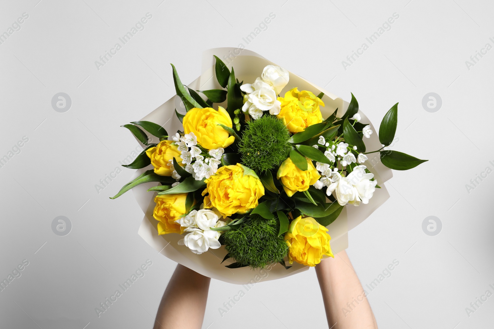 Photo of Woman with bouquet of beautiful tulips on white background, closeup