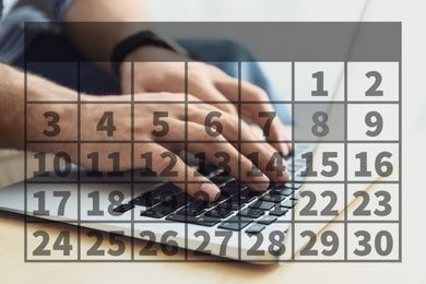 Image of Calendar and man working with laptop at wooden table, closeup