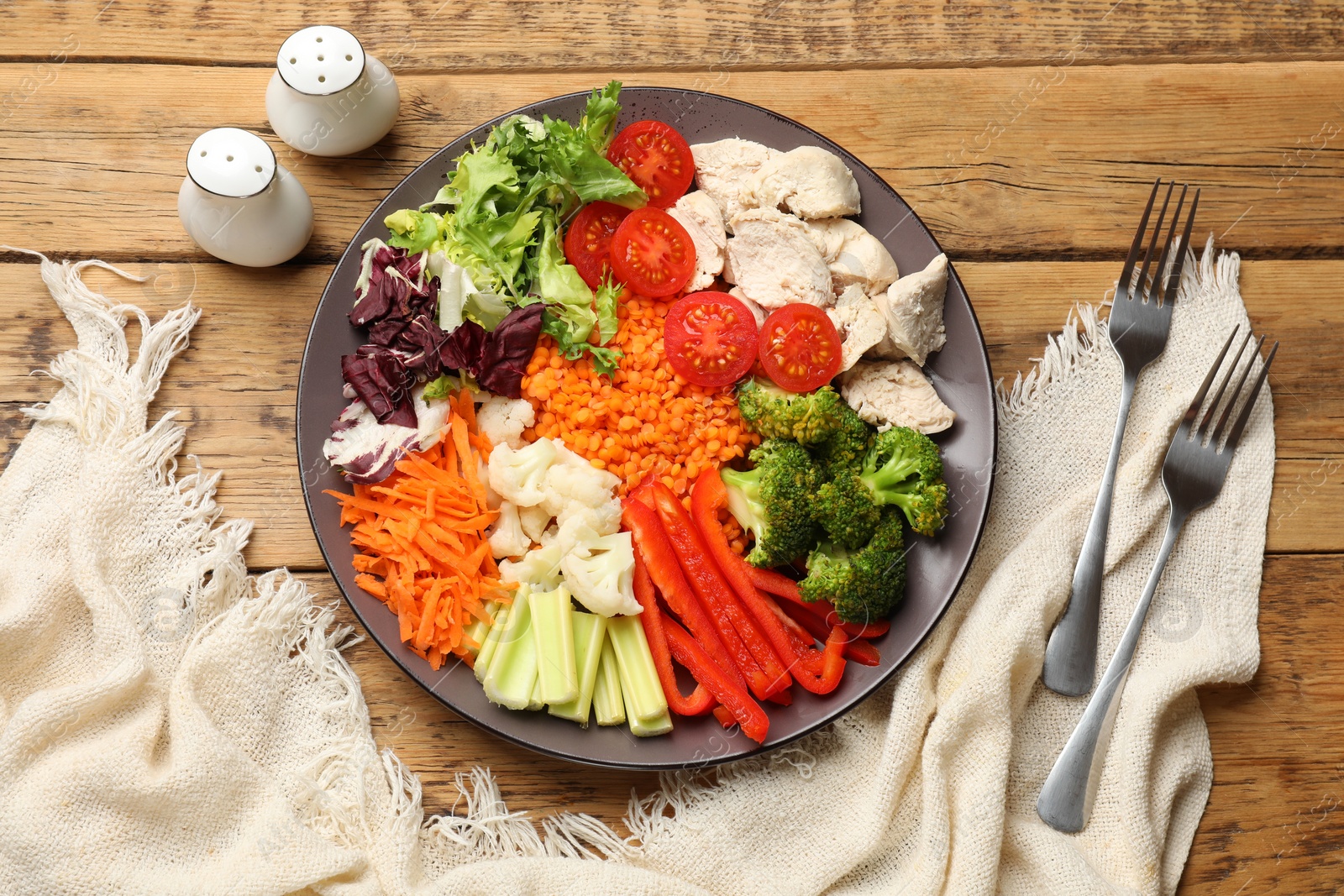 Photo of Balanced diet and healthy foods. Plate with different delicious products served on wooden table, top view