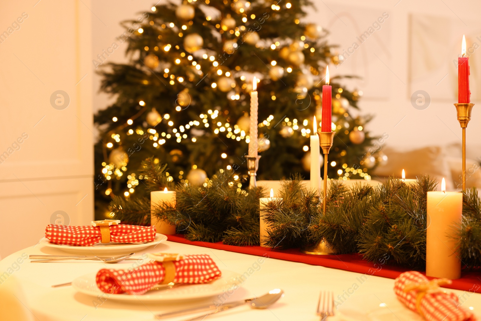 Photo of Festive table setting and beautiful Christmas decor in room. Interior design