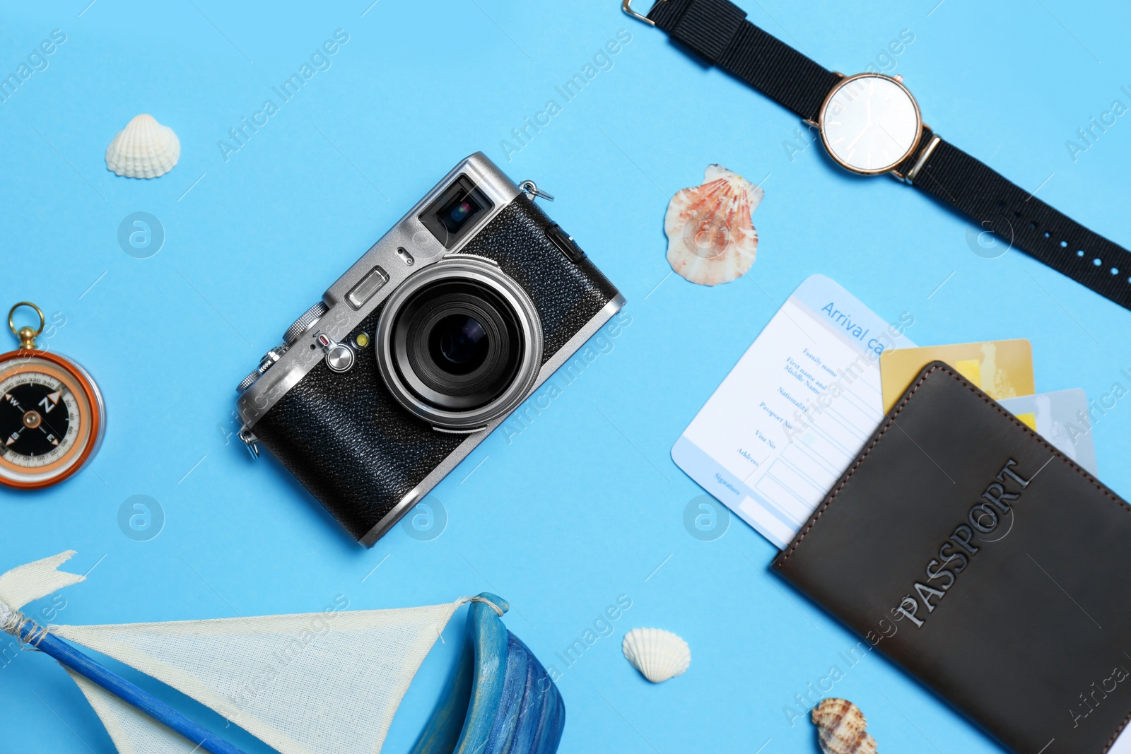 Photo of Flat lay composition with camera, passport and exotic seashells on color background. Professional photography