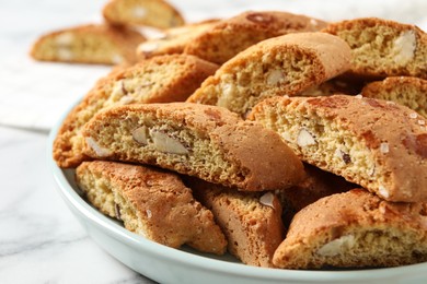 Traditional Italian almond biscuits (Cantucci) on white marble table, closeup