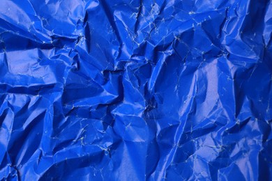 Photo of Sheet of crumpled blue paper as background, top view