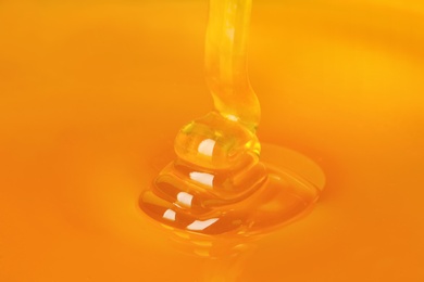 Photo of Pouring fresh sweet honey, closeup