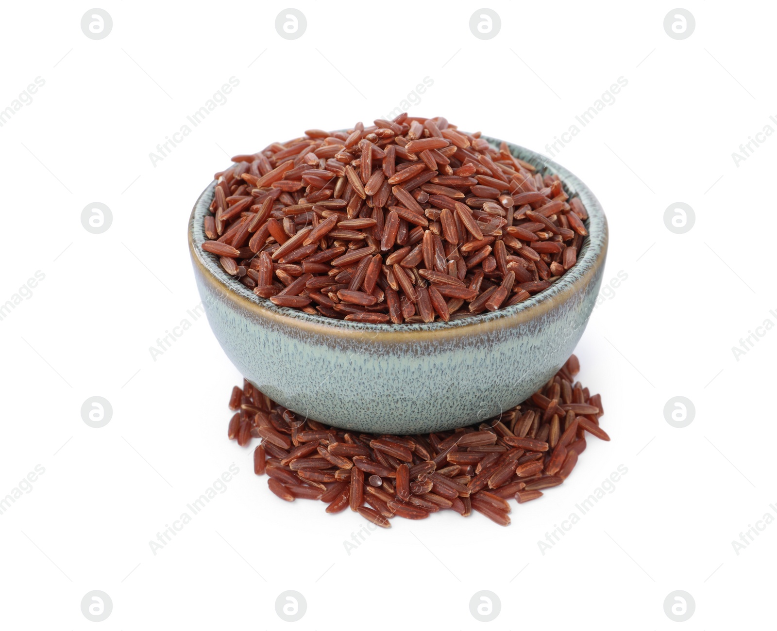 Photo of Bowl with raw red rice isolated on white