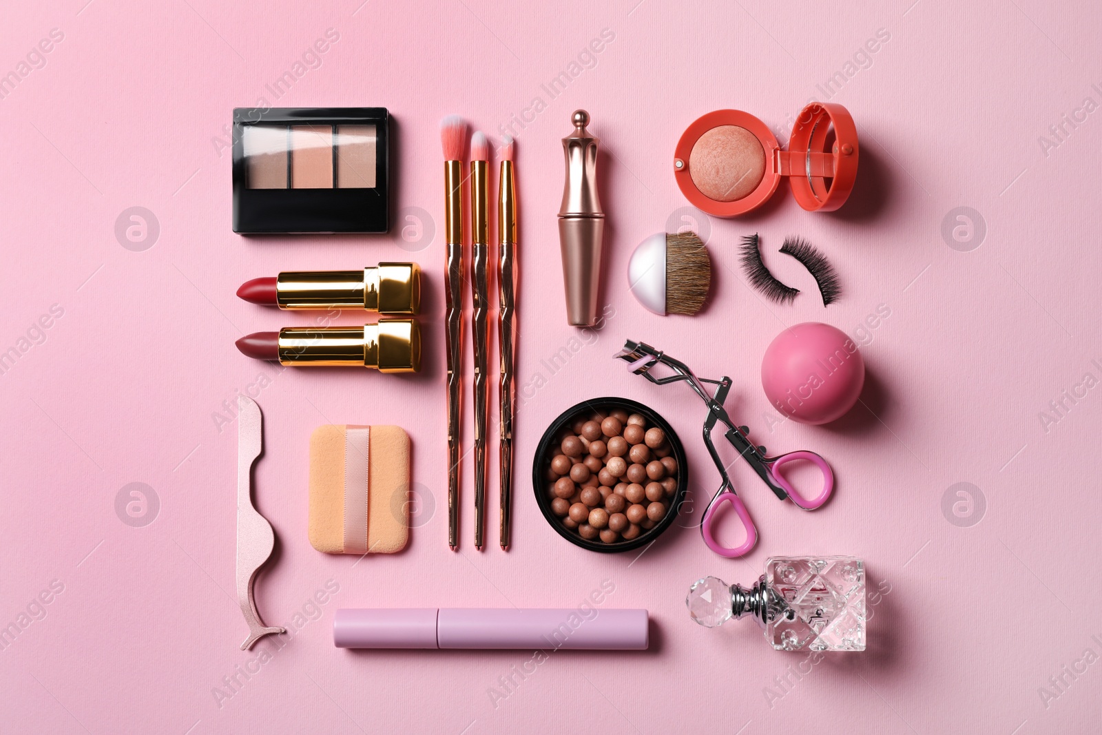 Photo of Flat lay composition with makeup products on pink background