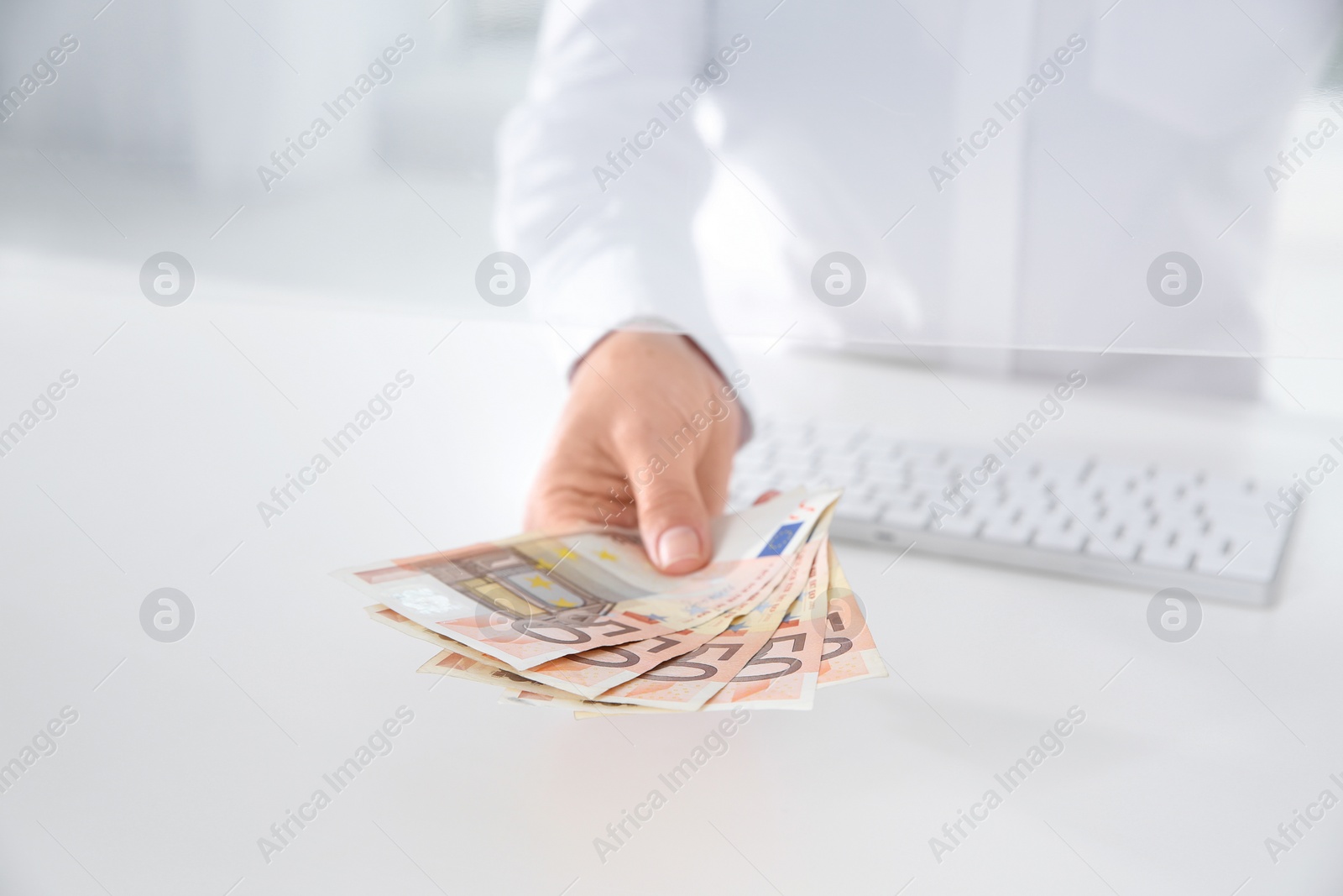 Photo of Teller with money at cash department window, closeup