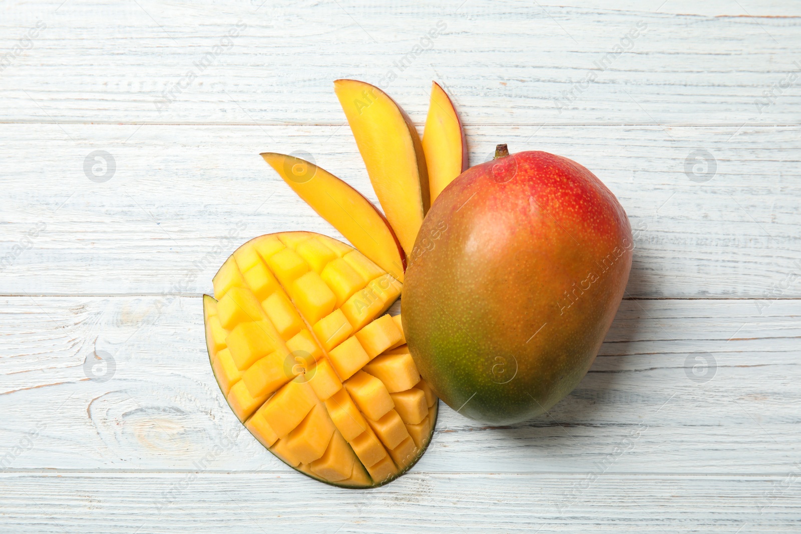 Photo of Flat lay composition with ripe mangoes on white wooden background