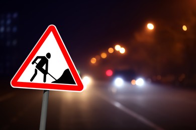 Image of Traffic sign Road Works near highway in night. Bokeh effect