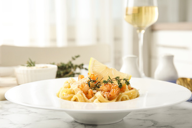 Delicious pasta with shrimps on white marble table