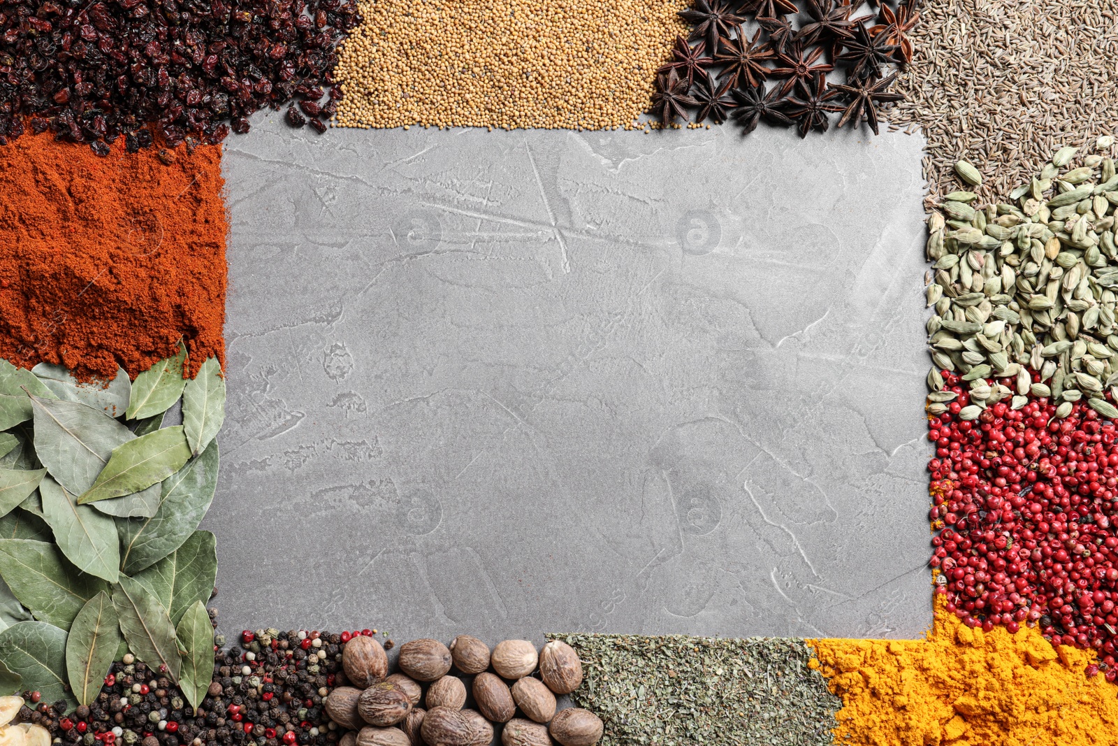 Photo of Frame made with different spices on grey background, flat lay. Space for text