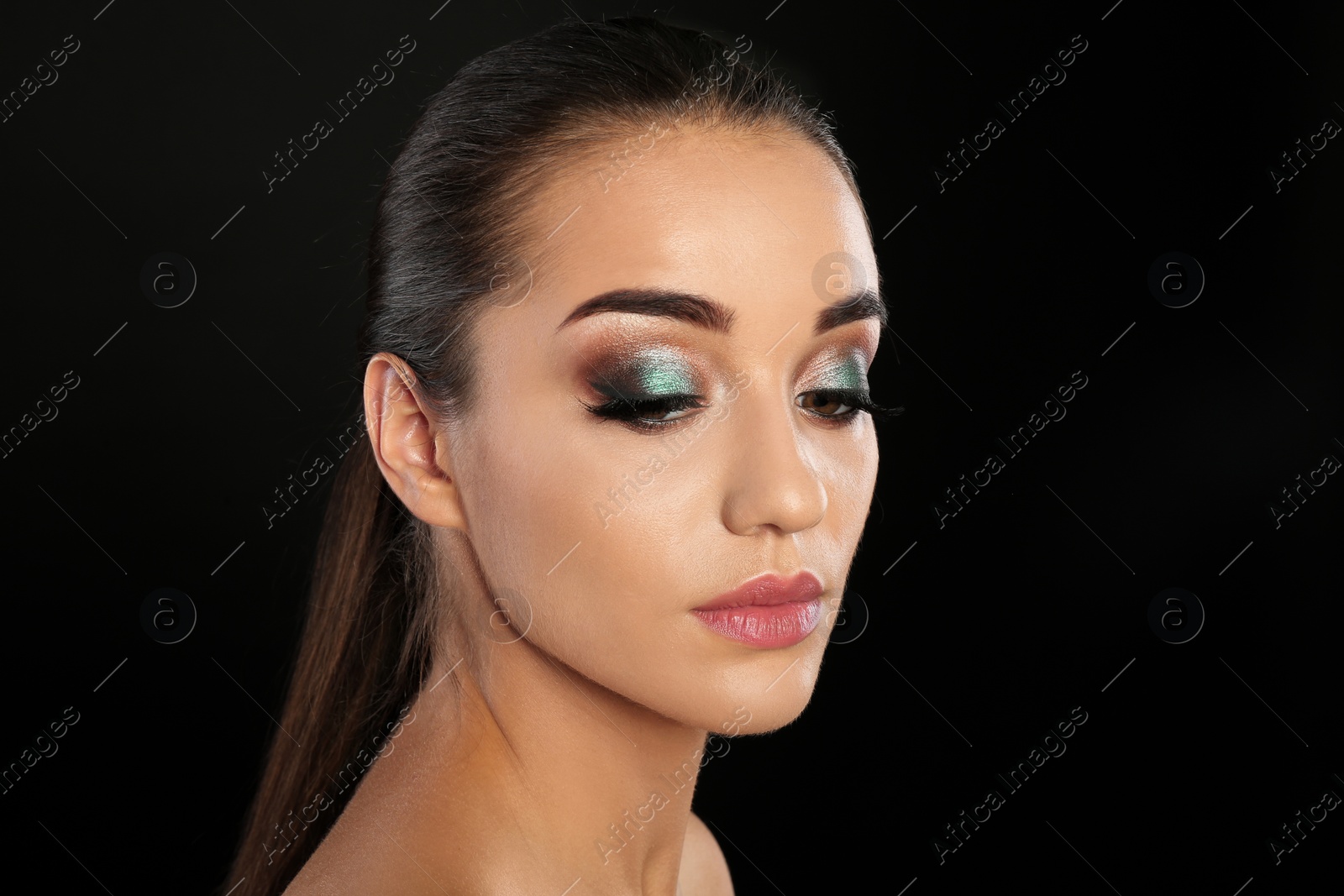 Photo of Portrait of young woman with eyelash extensions and beautiful makeup on black background. Space for text