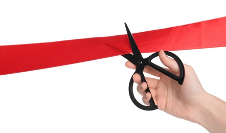 Photo of Woman cutting red ribbon on white background, closeup