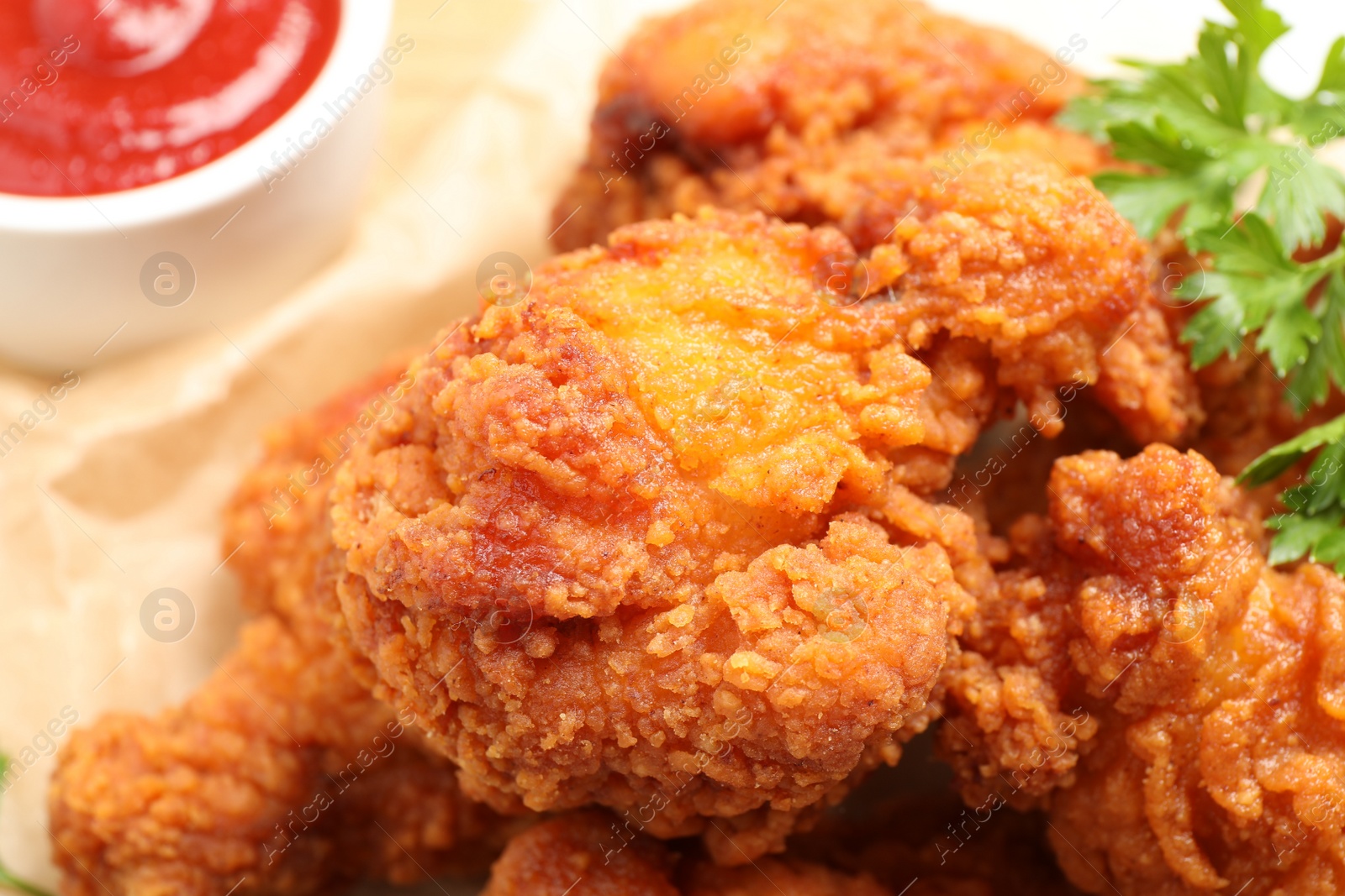 Photo of Tasty deep fried chicken pieces served on table, closeup