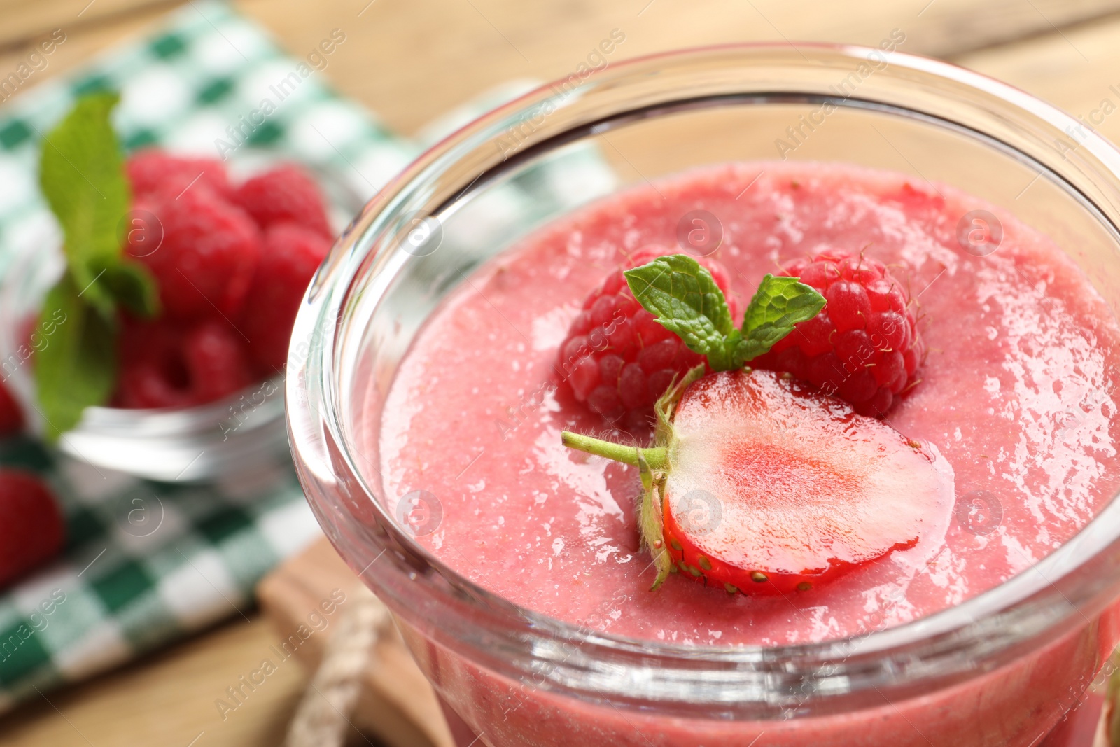Photo of Delicious berry mousse with mint in glass, closeup