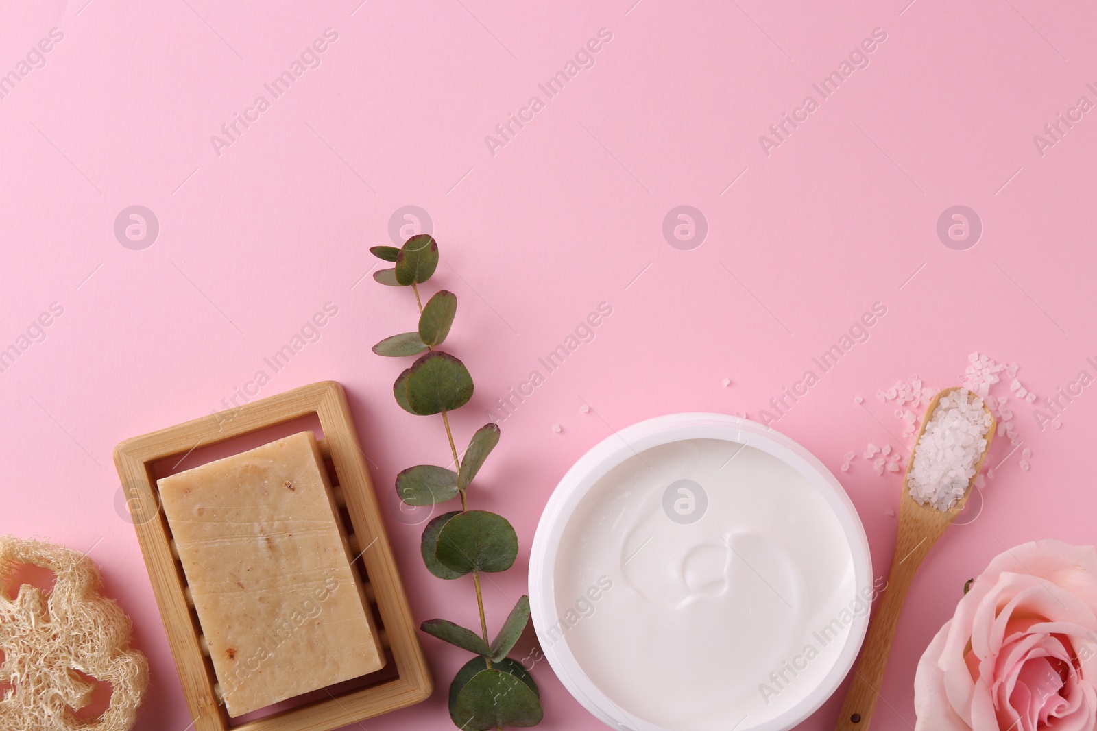 Photo of Jar of cream and body care products on pink background, flat lay. Space for text