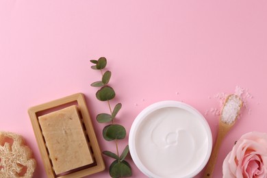 Jar of cream and body care products on pink background, flat lay. Space for text