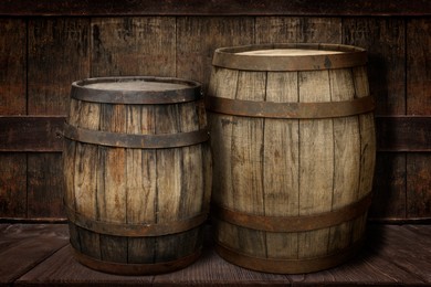 Image of Wooden barrels on brown shelf near textured wall