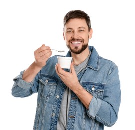 Handsome man with tasty yogurt on white background