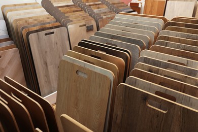 Photo of Many different samples of wooden flooring in store