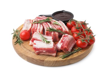 Photo of Cut raw pork ribs with rosemary, tomatoes and sauce isolated on white