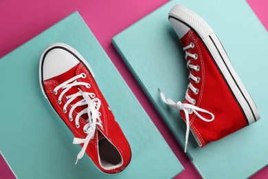 Pair of trendy sneakers on color background, flat lay