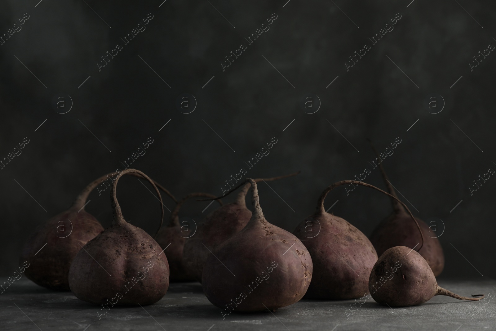 Photo of Ripe beets on table against black background