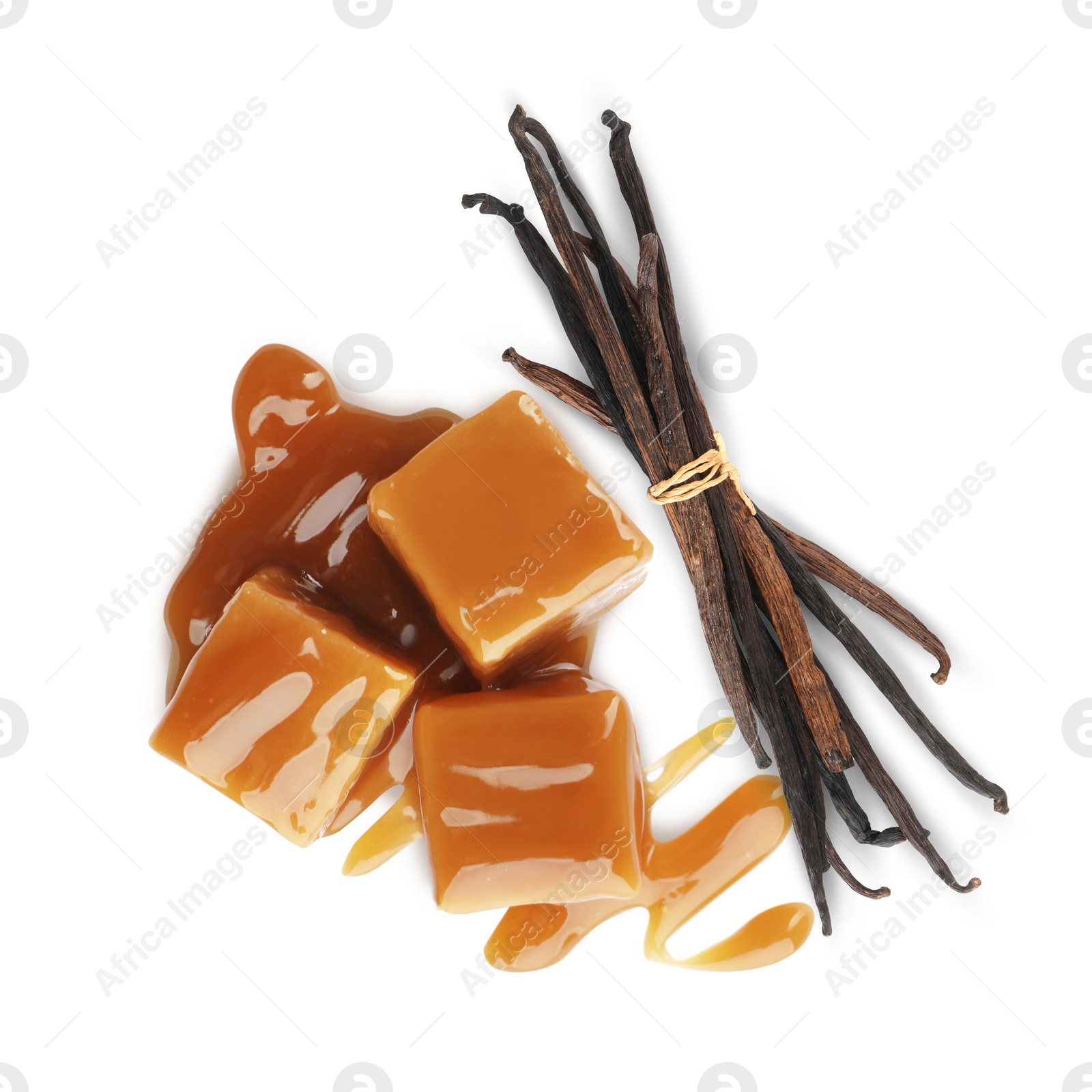 Image of Sweet caramel candies and vanilla pods isolated on white, top view