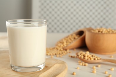 Photo of Fresh soy milk and beans on table. Space for text