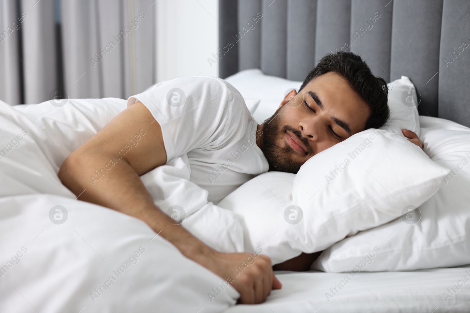 Photo of Handsome man sleeping in bed at morning