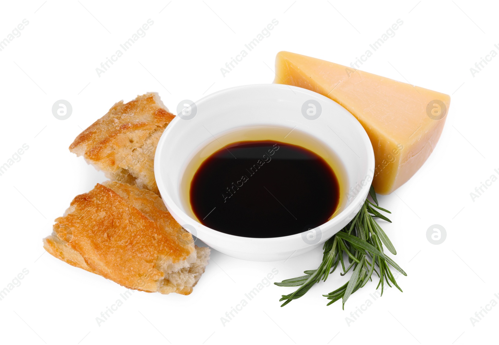 Photo of Bowl of balsamic vinegar with oil, bread, parmesan cheese and rosemary on white background