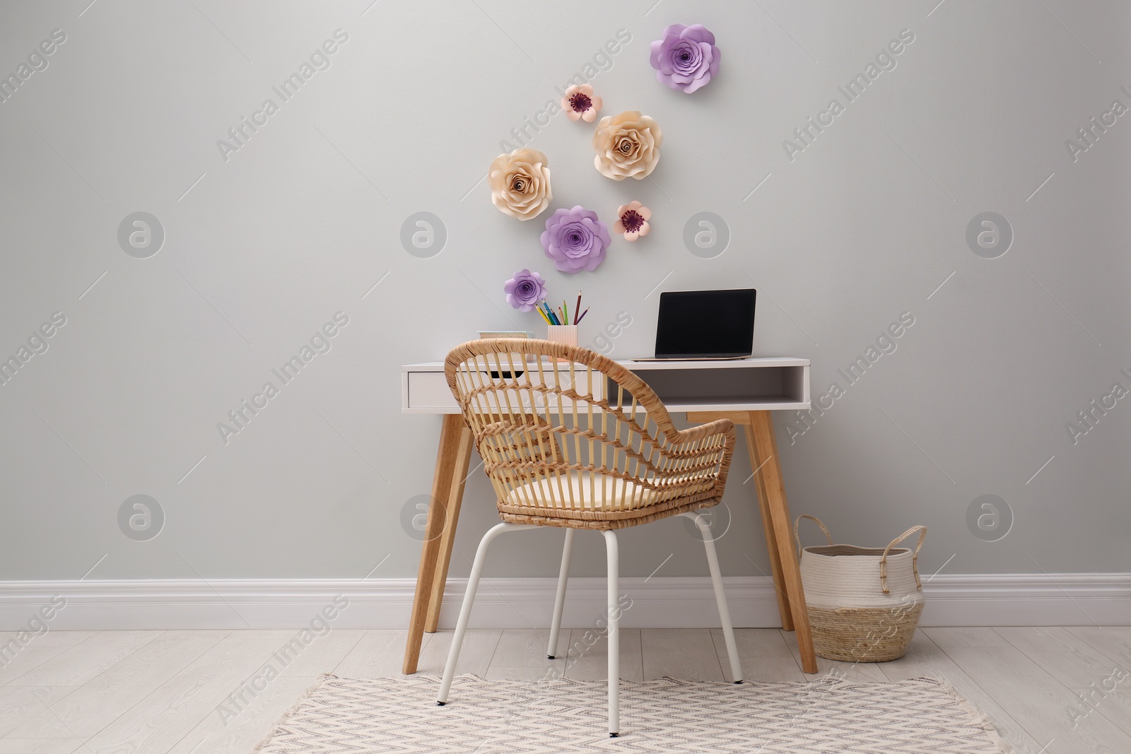 Photo of Stylish room interior with floral decor and modern furniture