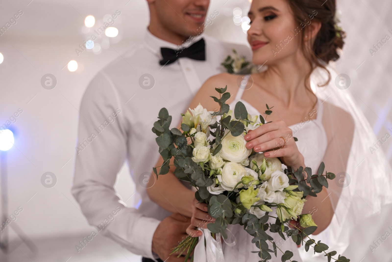 Photo of Happy newlywed couple together in festive hall, focus on hands