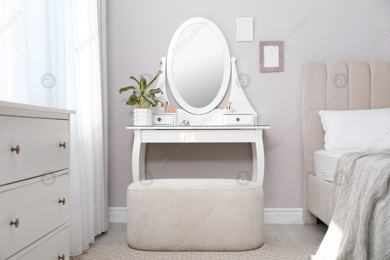 Photo of Elegant dressing table with mirror near window in bedroom