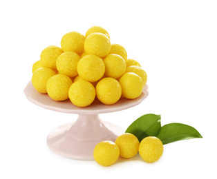 Tasty small lemon drops on white background