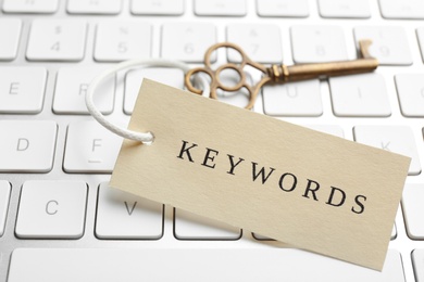 Key with tag KEYWORDS on computer keyboard, closeup