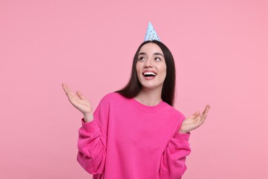 Photo of Happy woman in party hat on pink background