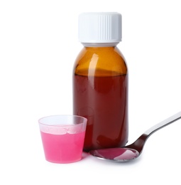 Spoon, measuring cup and bottle of cough syrup on white background