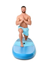 Photo of Happy man practicing yoga on blue SUP board against white background