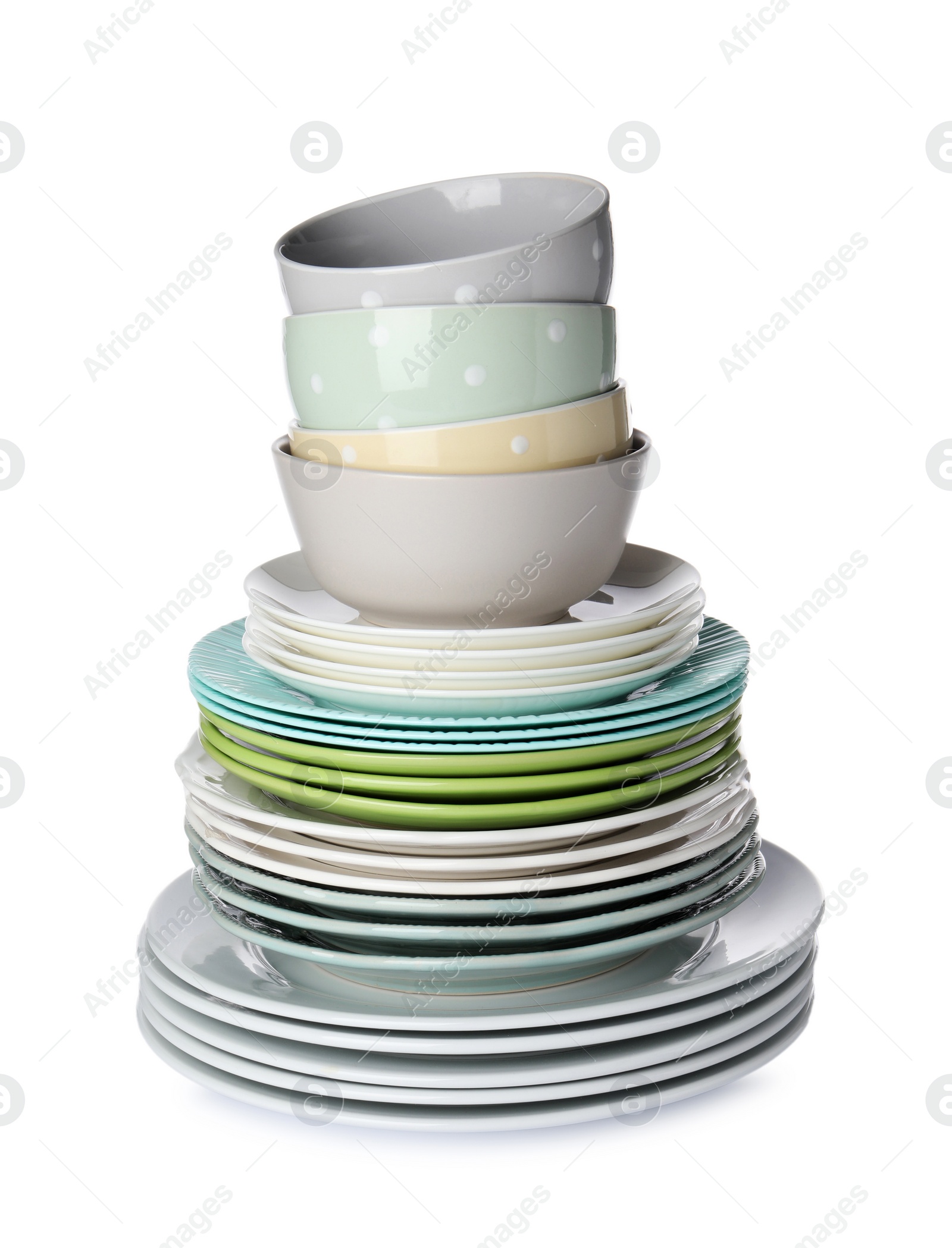 Photo of Beautiful ceramic plates and bowls isolated on white