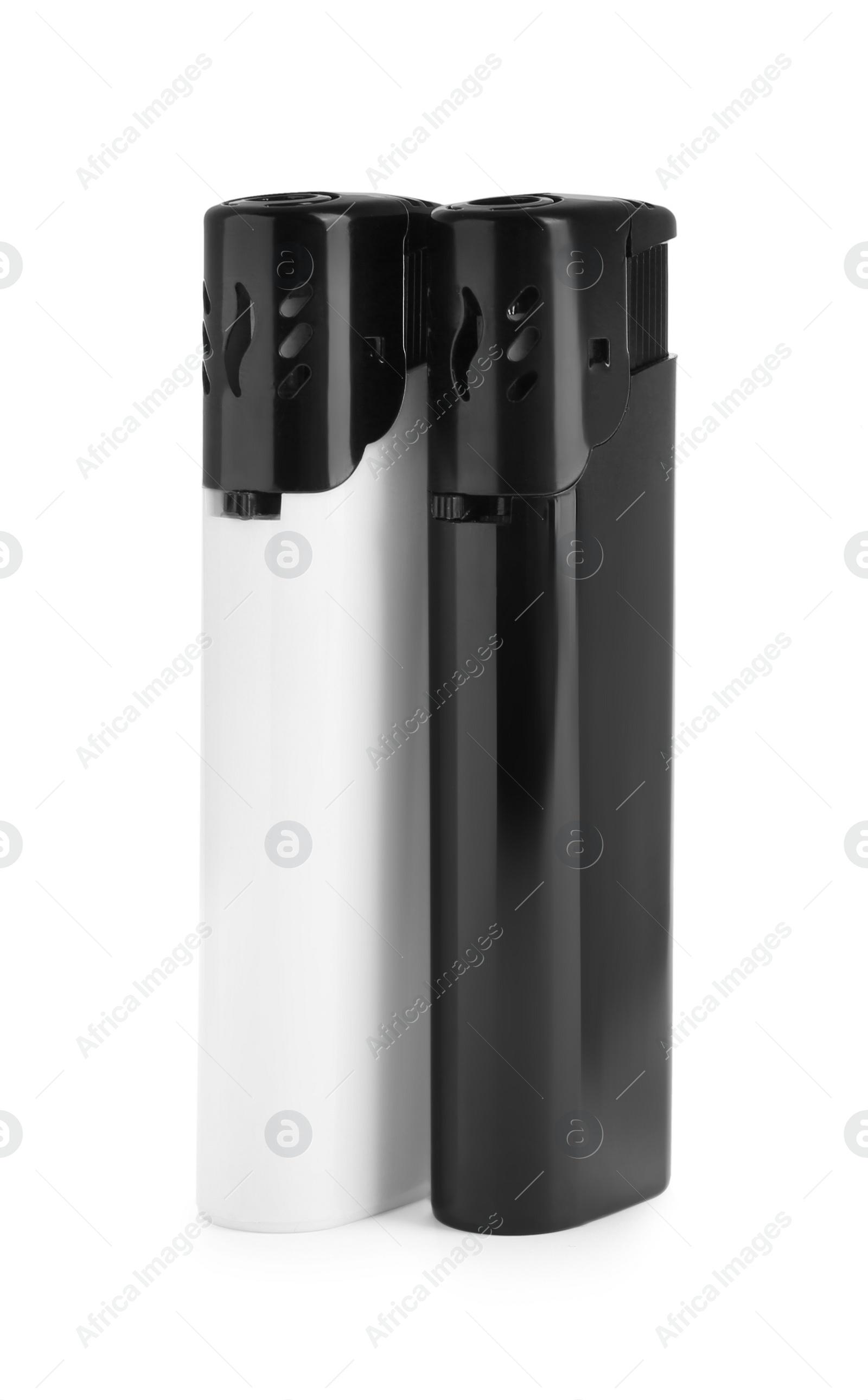 Photo of Stylish small pocket lighters on white background