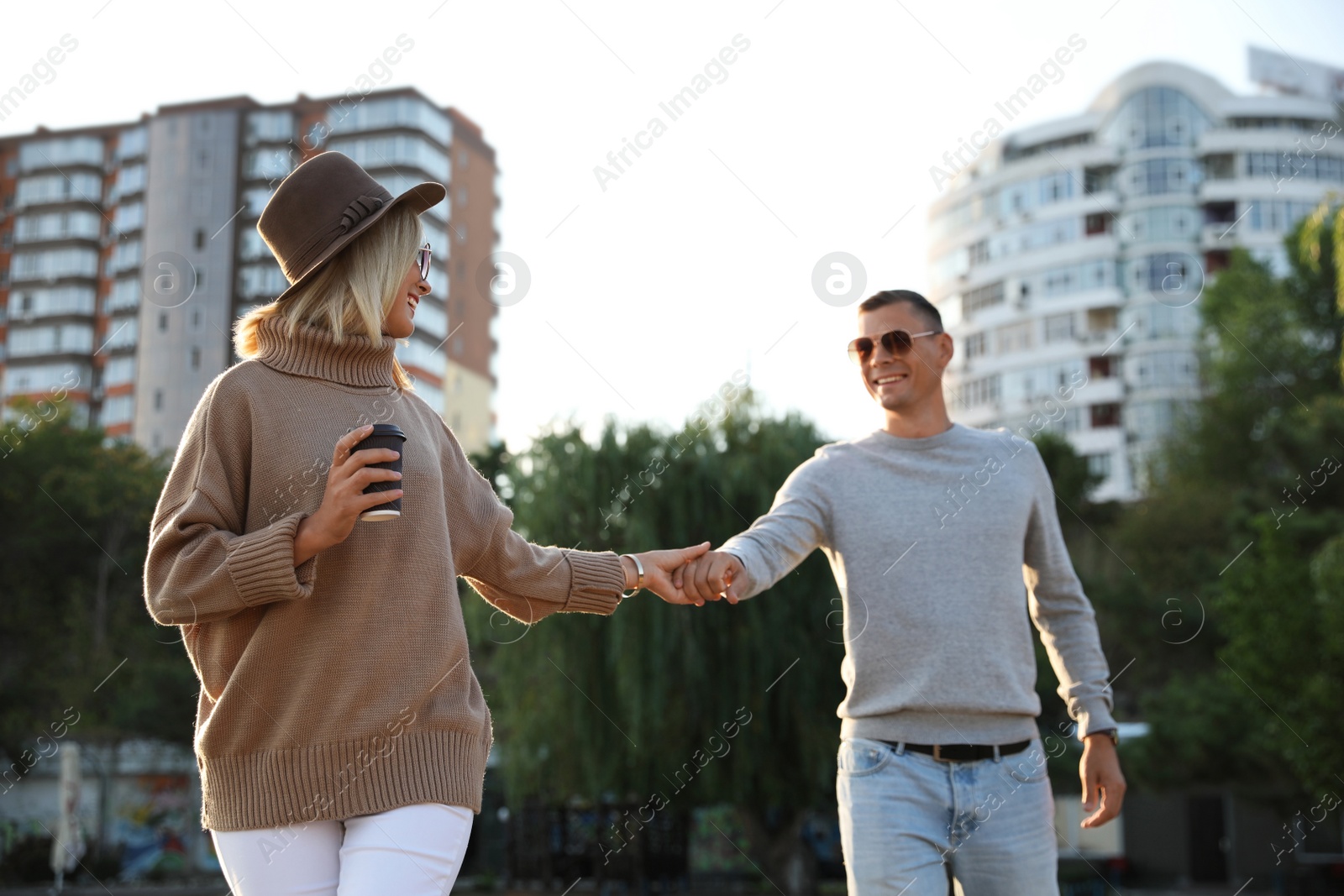 Photo of Couple in stylish sweaters on city street