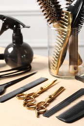 Hairdresser tools. Different scissors and combs on wooden table in salon