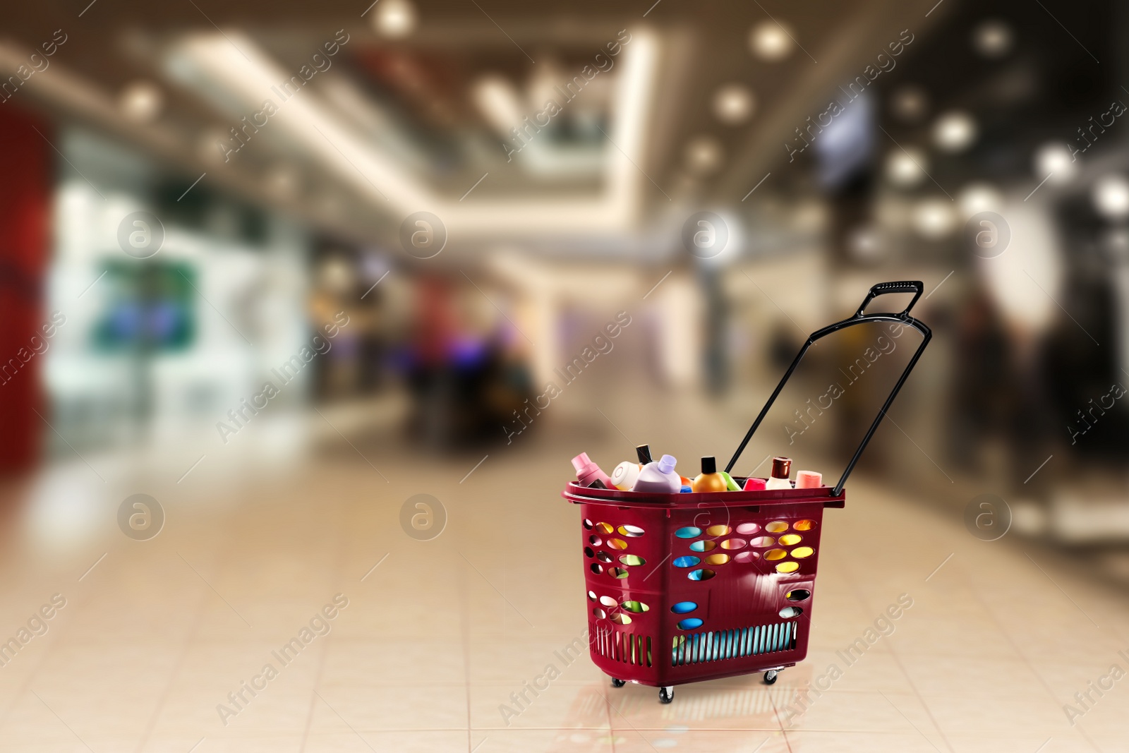 Image of Shopping basket full of cleaning supplies in mall