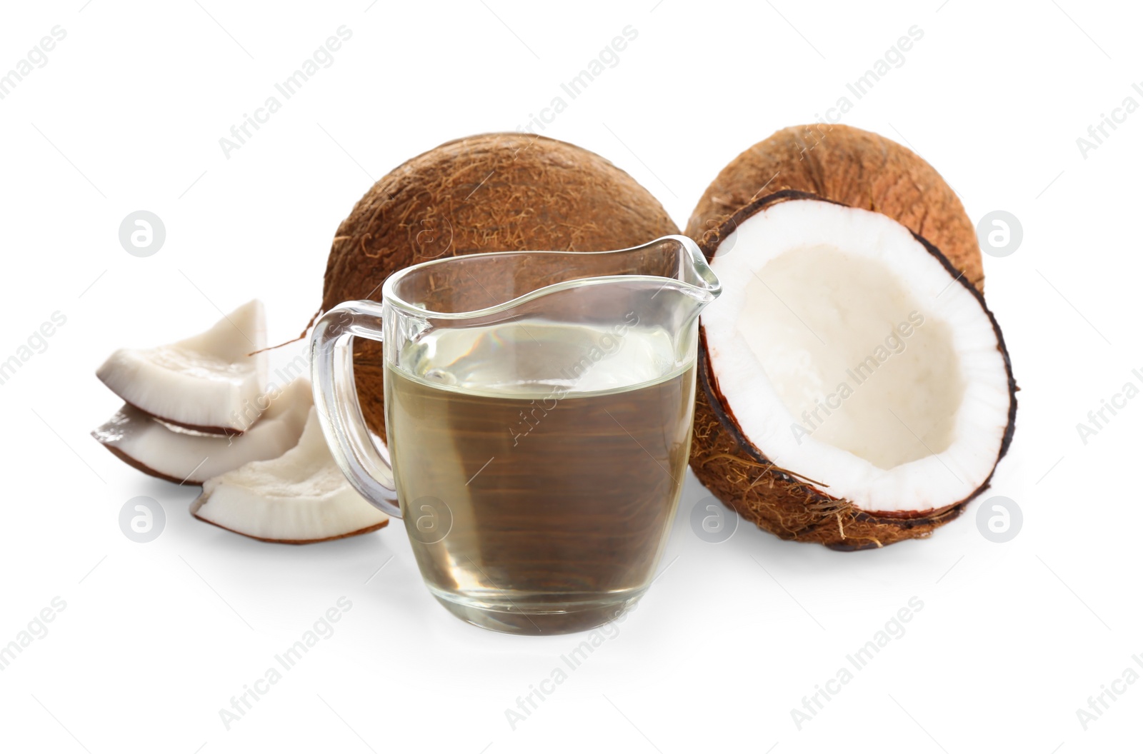 Photo of Ripe coconuts and pitcher with natural organic oil on white background