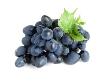 Photo of Bunch of dark blue grapes with green leaves isolated on white