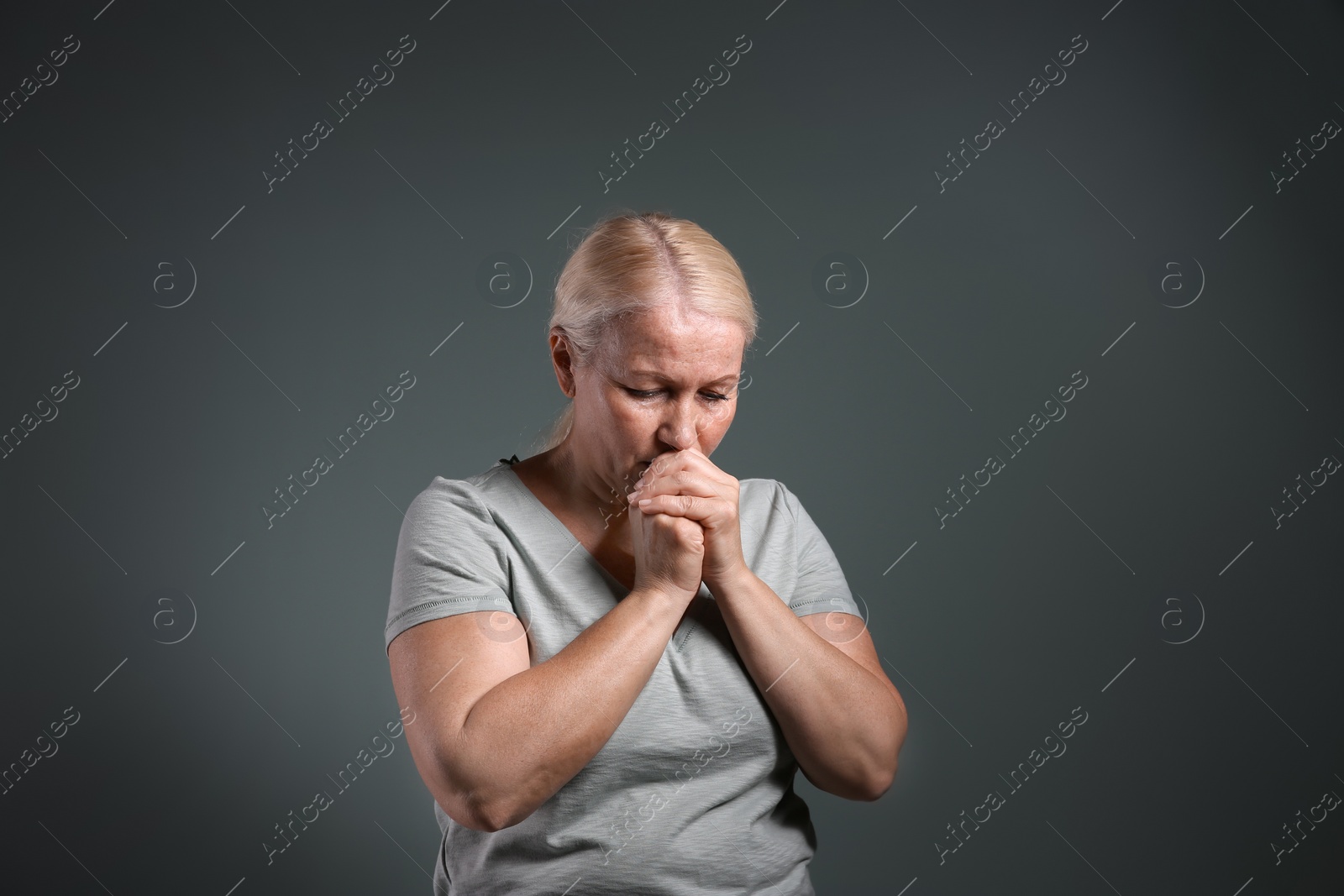 Photo of Mature woman suffering from depression on grey background