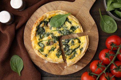 Photo of Delicious pie with spinach on wooden table, flat lay